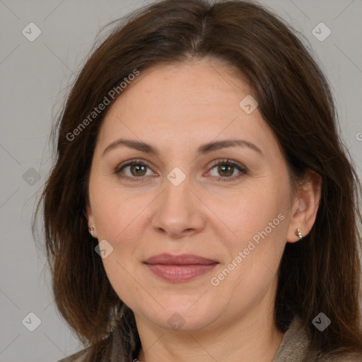 Joyful white adult female with long  brown hair and brown eyes