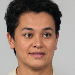 Joyful latino young-adult male with short  brown hair and brown eyes