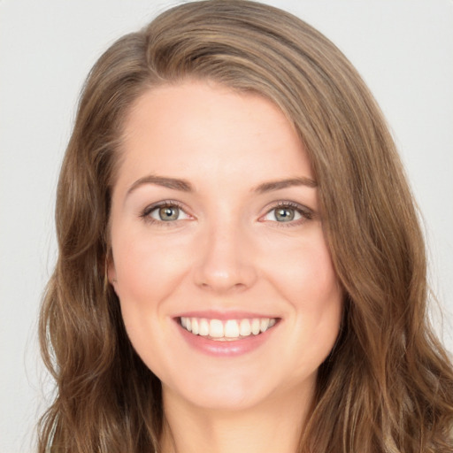 Joyful white young-adult female with long  brown hair and green eyes