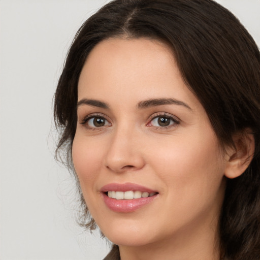 Joyful white young-adult female with medium  brown hair and brown eyes