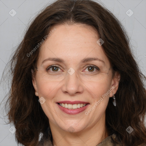 Joyful white adult female with long  brown hair and brown eyes