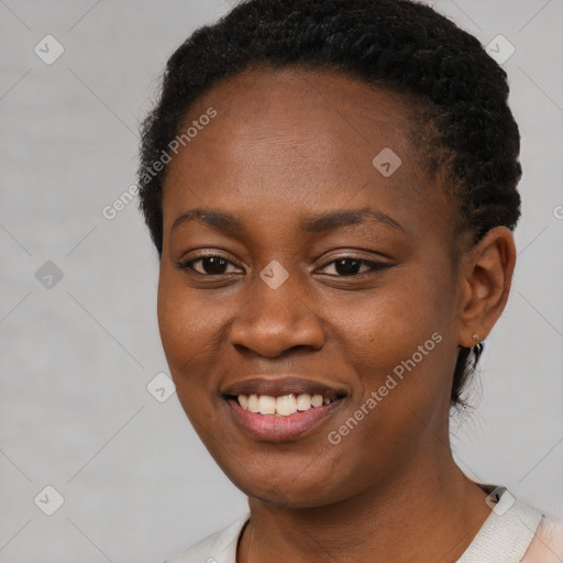 Joyful black young-adult female with short  black hair and brown eyes