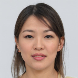 Joyful asian young-adult female with medium  brown hair and brown eyes