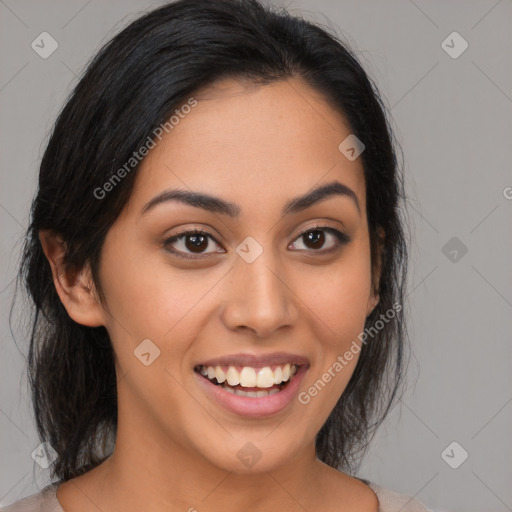 Joyful latino young-adult female with medium  black hair and brown eyes