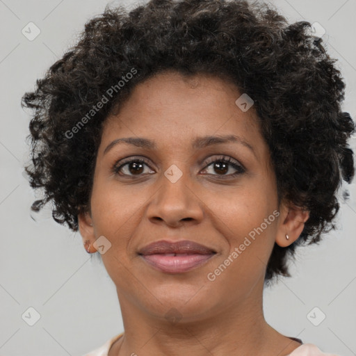 Joyful black adult female with short  brown hair and brown eyes