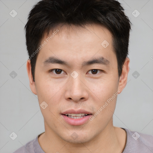 Joyful asian young-adult male with short  brown hair and brown eyes