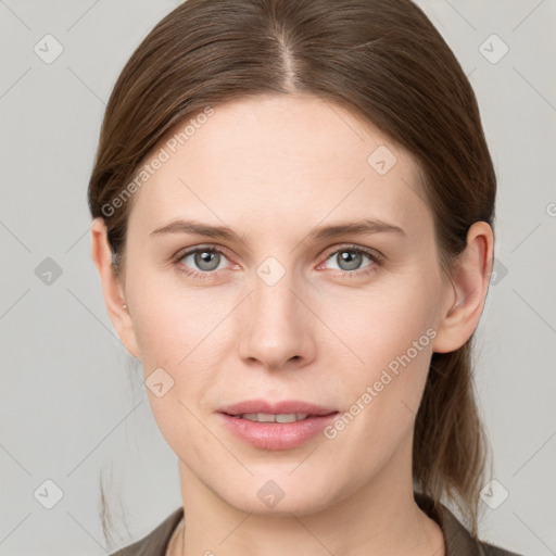 Joyful white young-adult female with medium  brown hair and grey eyes