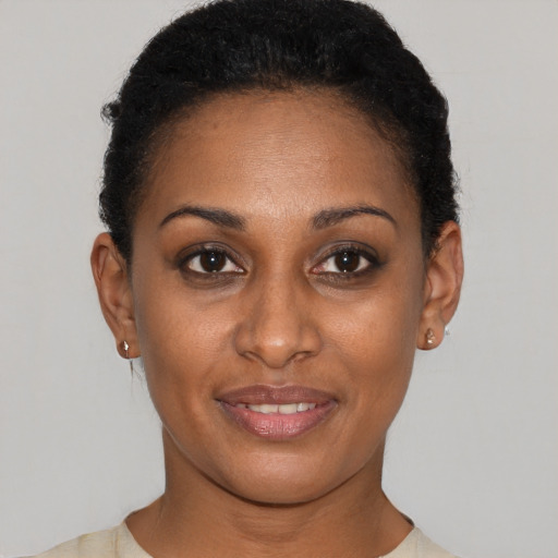 Joyful black young-adult female with short  brown hair and brown eyes