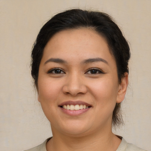 Joyful asian young-adult female with medium  brown hair and brown eyes