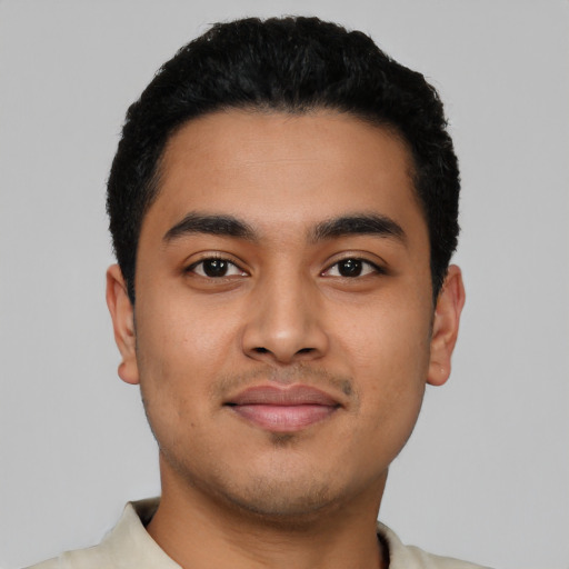 Joyful latino young-adult male with short  black hair and brown eyes