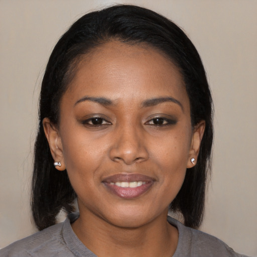 Joyful black young-adult female with medium  black hair and brown eyes