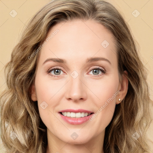 Joyful white young-adult female with long  brown hair and green eyes