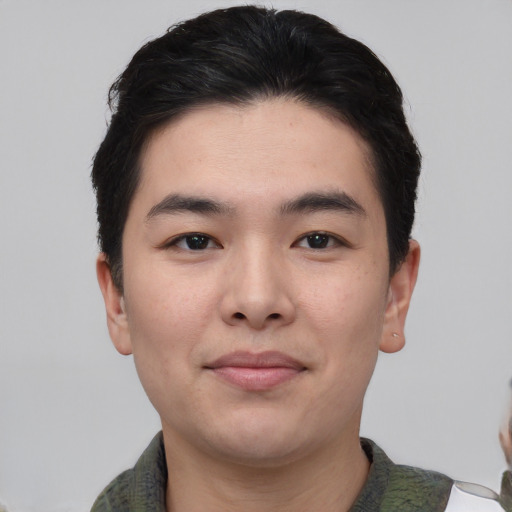 Joyful asian young-adult male with short  black hair and brown eyes
