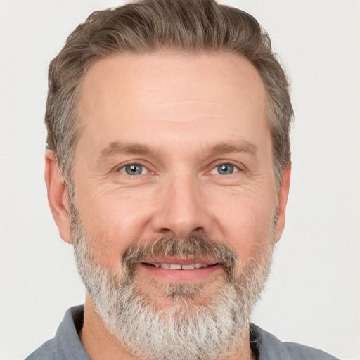 Joyful white adult male with short  brown hair and grey eyes