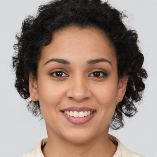 Joyful latino young-adult female with medium  brown hair and brown eyes