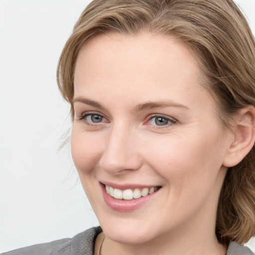 Joyful white young-adult female with medium  brown hair and blue eyes