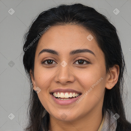 Joyful latino young-adult female with long  brown hair and brown eyes