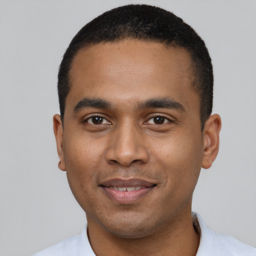 Joyful black young-adult male with short  black hair and brown eyes