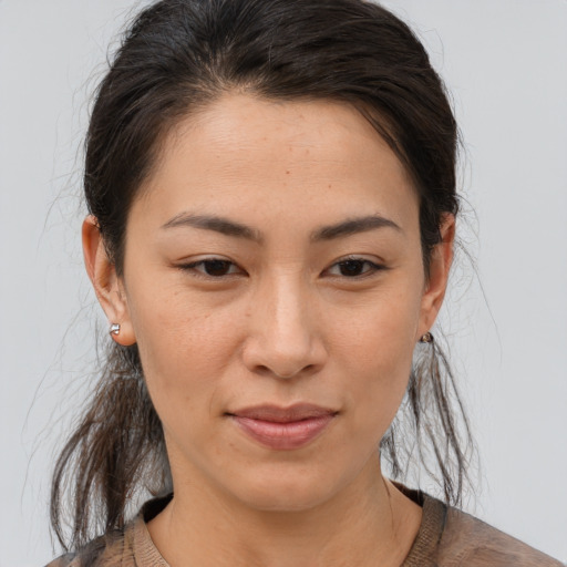 Joyful asian young-adult female with medium  brown hair and brown eyes