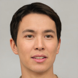 Joyful asian young-adult male with short  brown hair and brown eyes