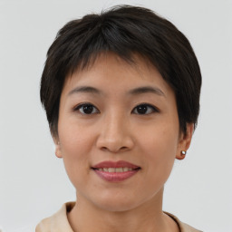 Joyful asian young-adult female with short  brown hair and brown eyes