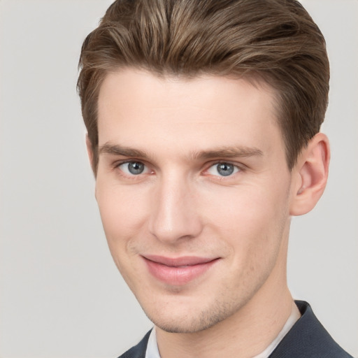 Joyful white young-adult male with short  brown hair and grey eyes