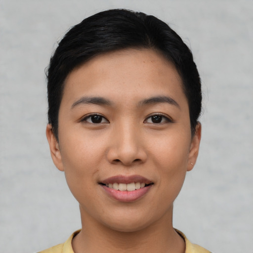 Joyful asian young-adult female with short  black hair and brown eyes