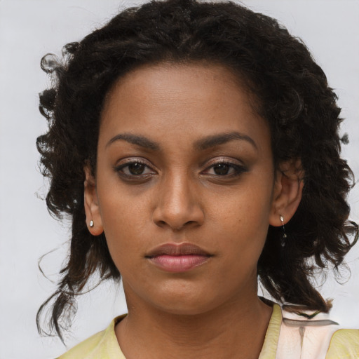 Neutral black young-adult female with medium  brown hair and brown eyes
