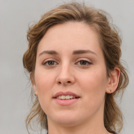 Joyful white young-adult female with medium  brown hair and green eyes