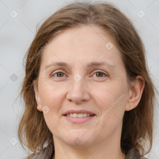 Joyful white adult female with medium  brown hair and grey eyes