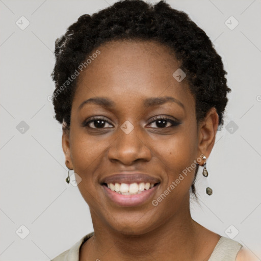 Joyful black young-adult female with short  black hair and brown eyes