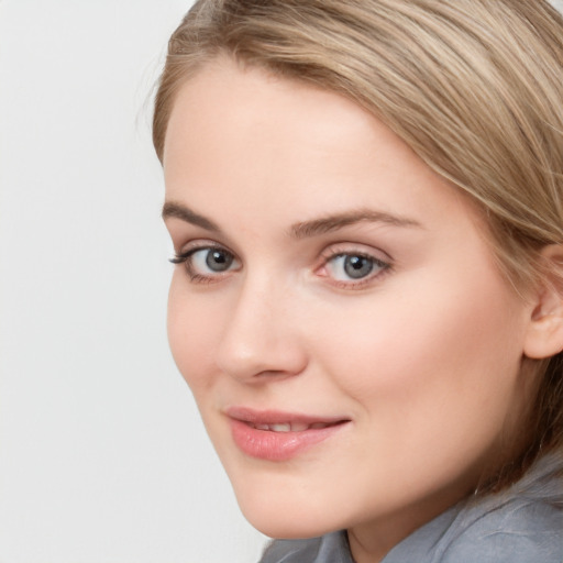 Joyful white young-adult female with long  brown hair and blue eyes