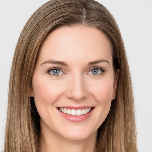 Joyful white young-adult female with long  brown hair and green eyes