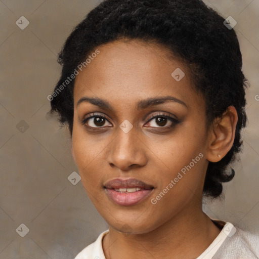 Joyful black young-adult female with short  black hair and brown eyes