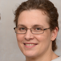 Joyful white adult female with medium  brown hair and grey eyes