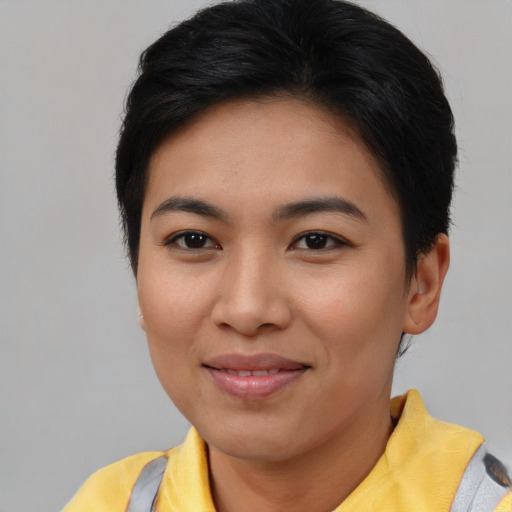 Joyful asian young-adult female with short  brown hair and brown eyes