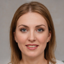 Joyful white young-adult female with medium  brown hair and blue eyes