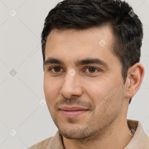 Joyful white young-adult male with short  black hair and brown eyes