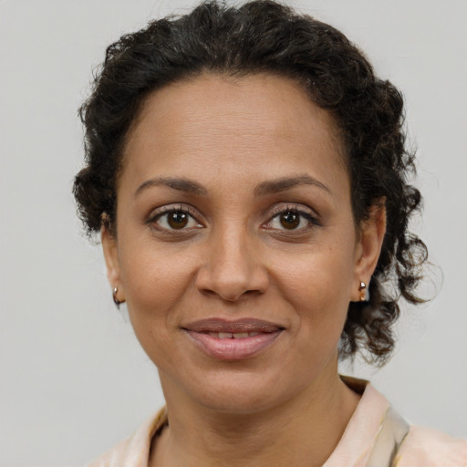 Joyful latino adult female with short  brown hair and brown eyes
