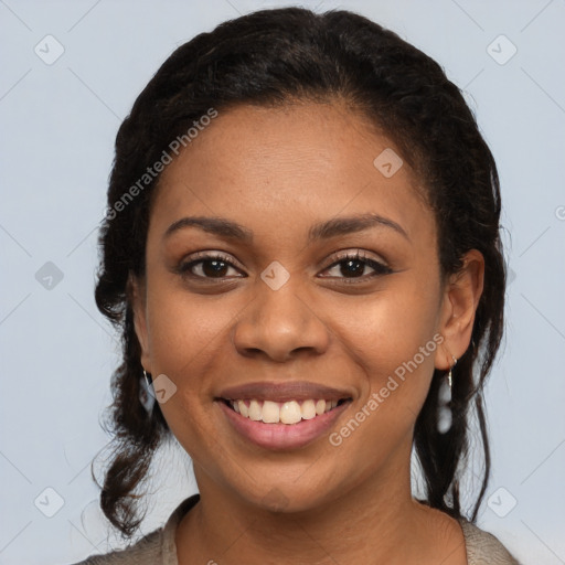 Joyful black young-adult female with long  brown hair and brown eyes