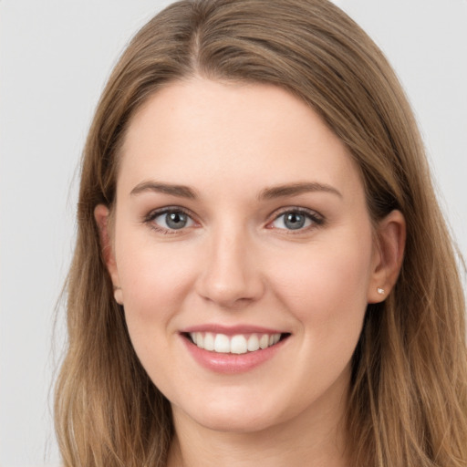 Joyful white young-adult female with long  brown hair and grey eyes