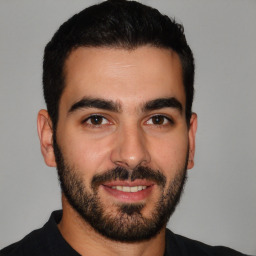 Joyful latino young-adult male with short  black hair and brown eyes