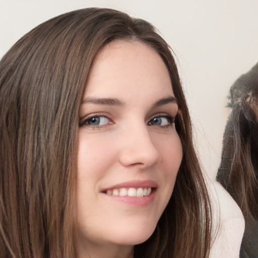 Joyful white young-adult female with long  brown hair and grey eyes