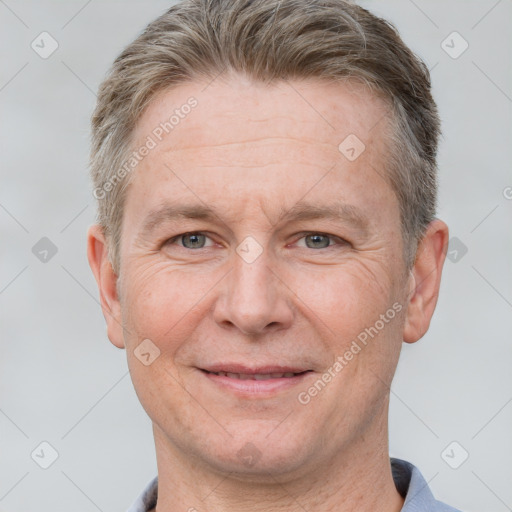 Joyful white adult male with short  brown hair and grey eyes