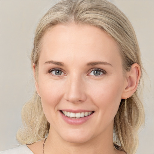 Joyful white young-adult female with medium  brown hair and blue eyes