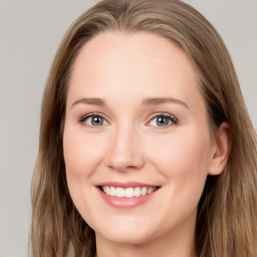 Joyful white young-adult female with long  brown hair and grey eyes