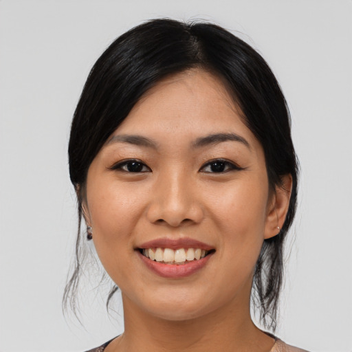 Joyful asian young-adult female with medium  black hair and brown eyes