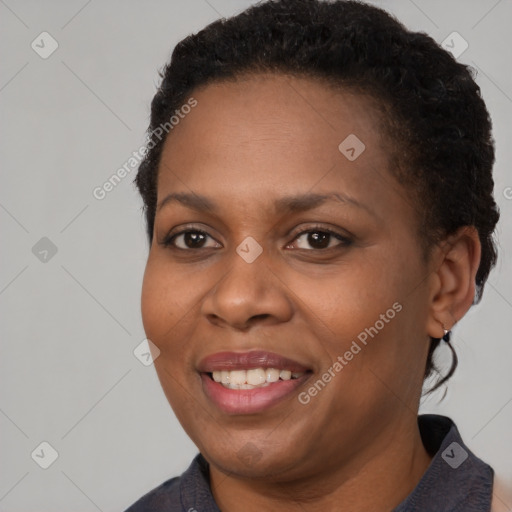 Joyful black young-adult female with short  brown hair and brown eyes