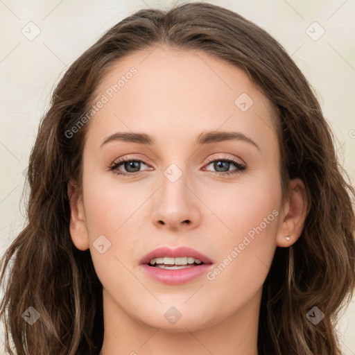 Joyful white young-adult female with long  brown hair and green eyes