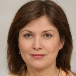 Joyful white adult female with medium  brown hair and brown eyes